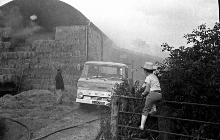 A lorry backing in to save some of the contents of the barn