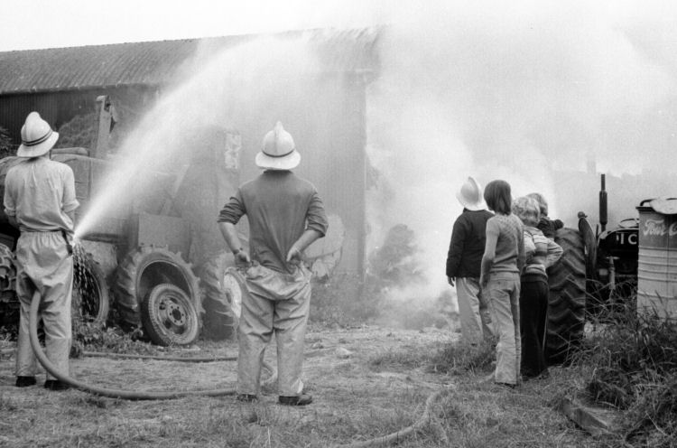 Water is sprayed onto the barn to reduce damage to the structure
