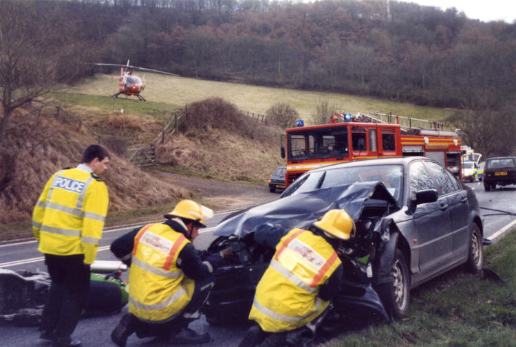 The air ambulance stands by as firefighters deal with an RTA on Fish Hill